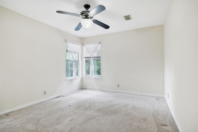 spare room with light carpet and ceiling fan