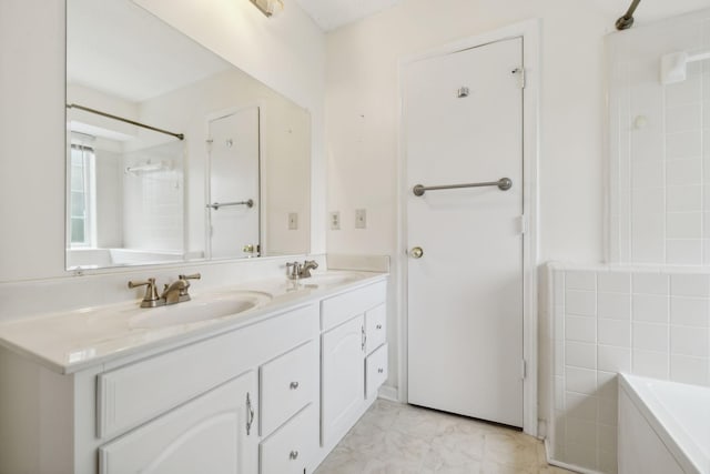 bathroom with a washtub and vanity