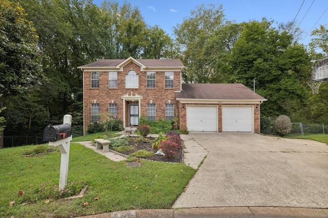 colonial house featuring a front yard and a garage