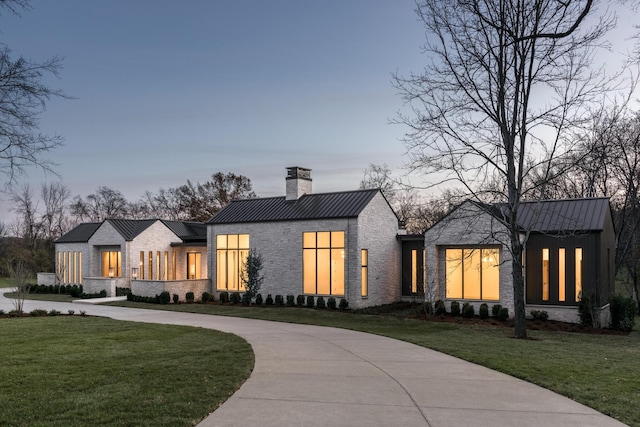 modern farmhouse style home with a lawn