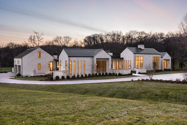 modern inspired farmhouse with a yard