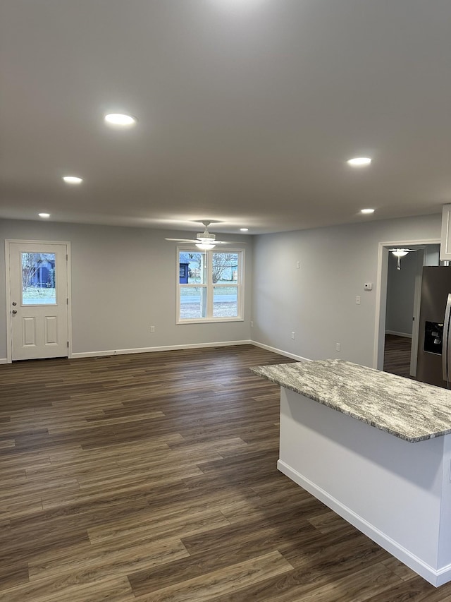 interior space featuring ceiling fan and dark wood-type flooring