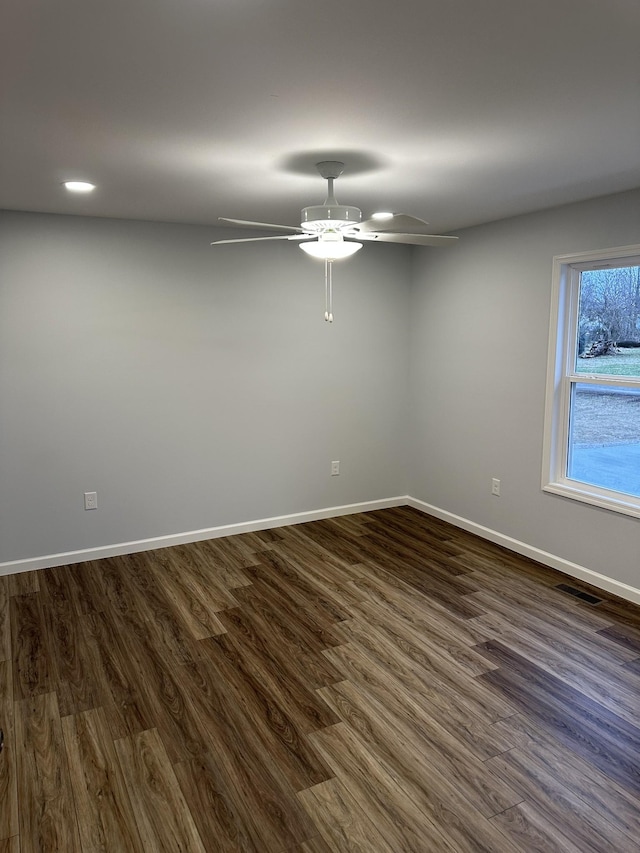 unfurnished room with dark wood-type flooring