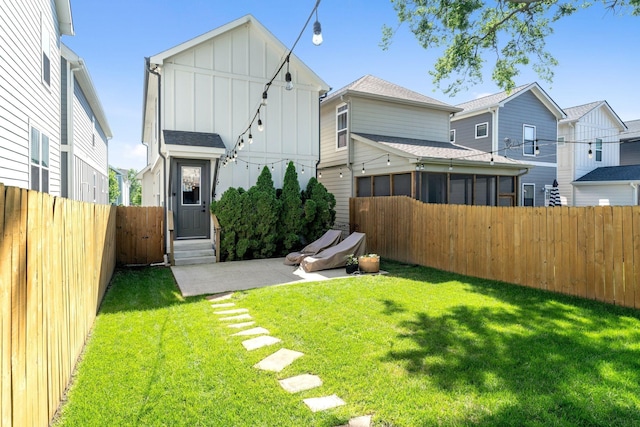 back of house featuring a yard and a patio