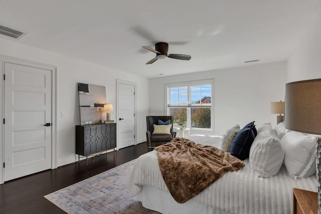 bedroom with ceiling fan and dark wood-type flooring