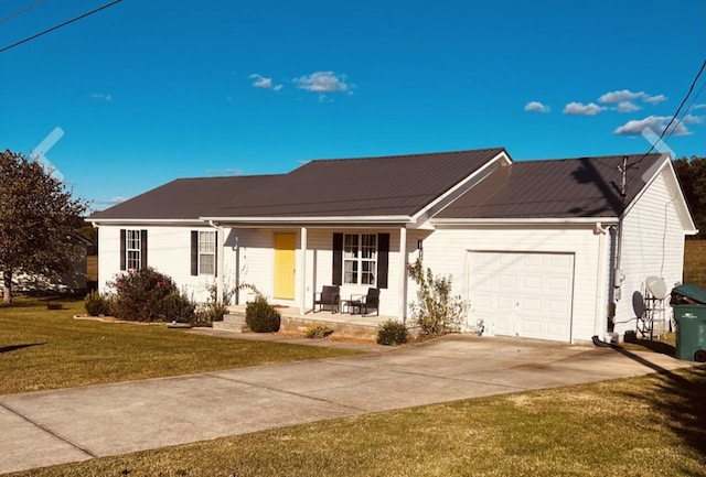 ranch-style house with covered porch, a garage, and a front yard