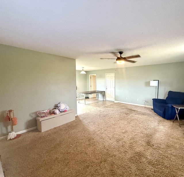 living room with carpet and ceiling fan