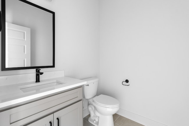 bathroom featuring vanity, tile patterned floors, and toilet