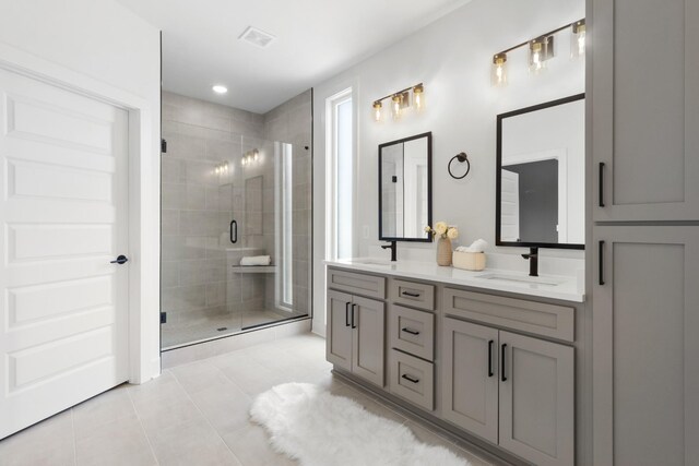 bathroom with tile patterned flooring, vanity, and an enclosed shower