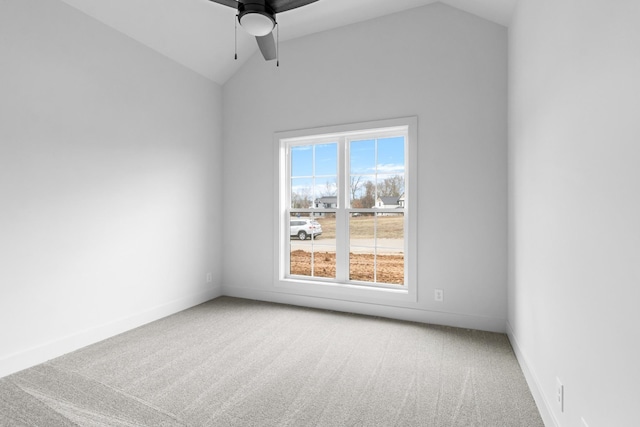 carpeted empty room featuring ceiling fan and lofted ceiling