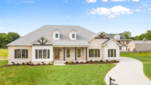 view of front of property with covered porch and a front lawn