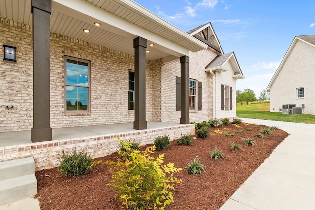 view of side of property featuring central air condition unit and covered porch