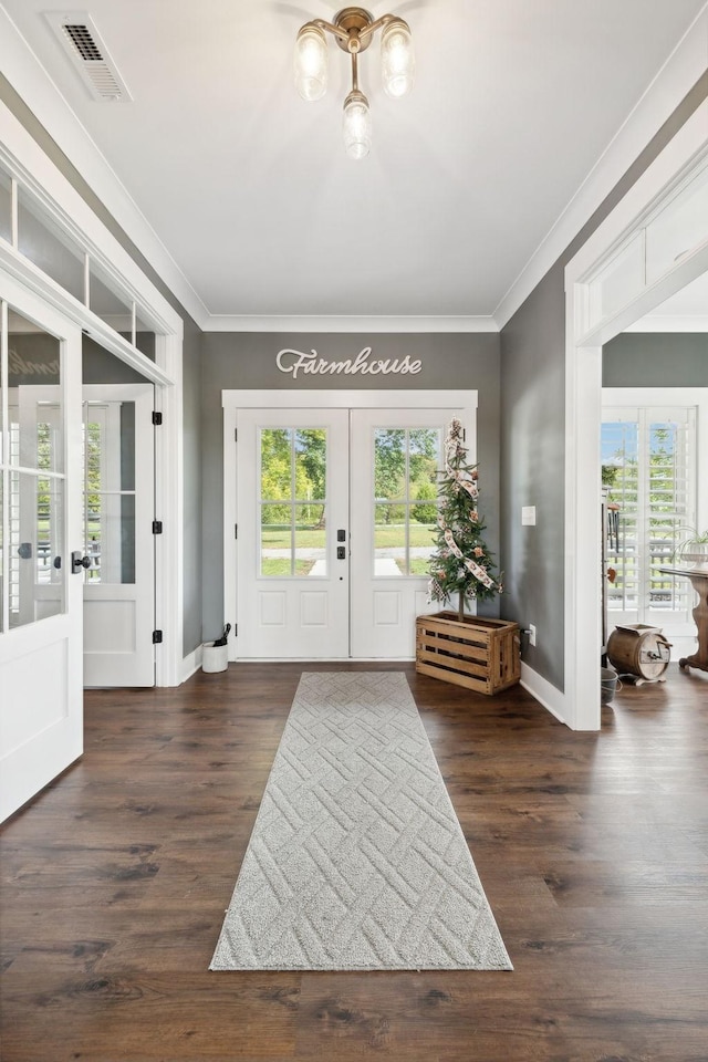 doorway with french doors, crown molding, dark wood-type flooring, and a healthy amount of sunlight