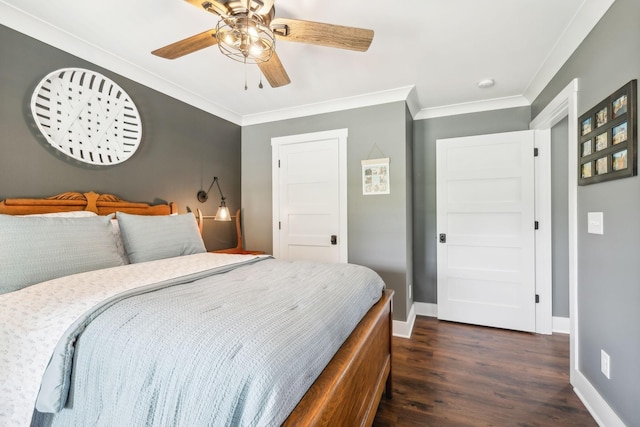 bedroom with ceiling fan, ornamental molding, and dark wood-type flooring