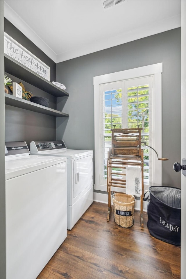 laundry area with washing machine and dryer and dark hardwood / wood-style floors