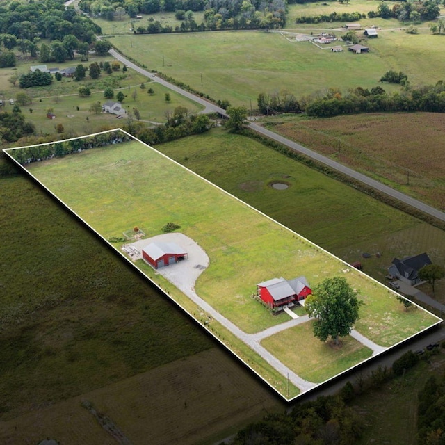 birds eye view of property with a rural view