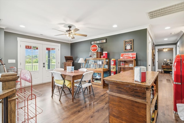 dining space featuring french doors, dark hardwood / wood-style flooring, ceiling fan, and crown molding