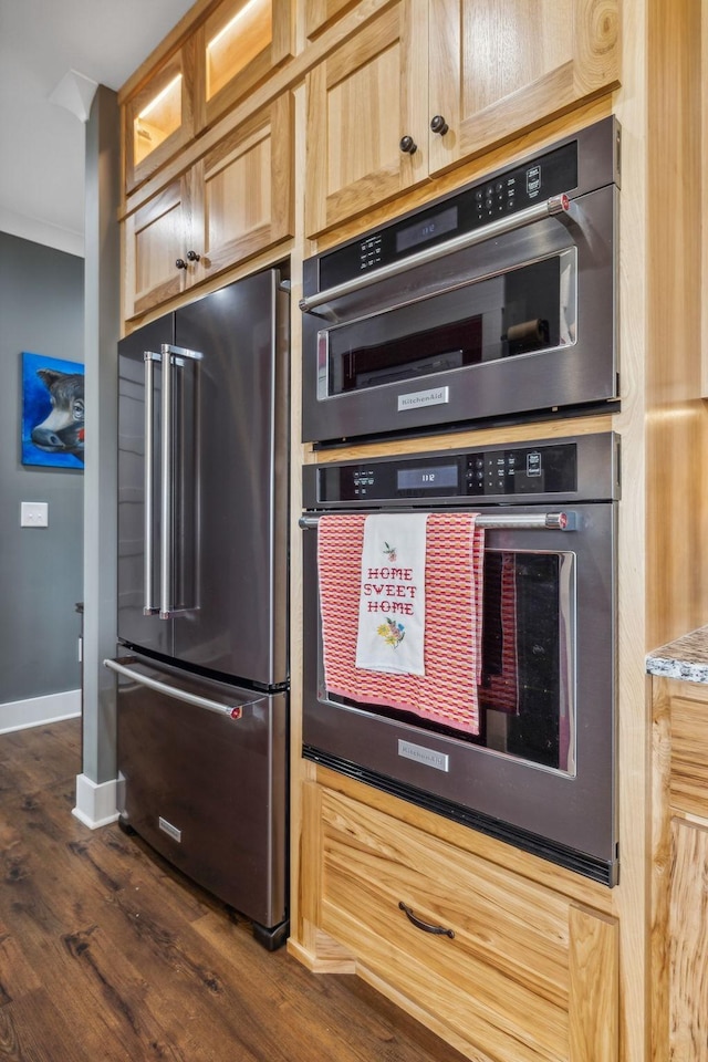 kitchen with dark hardwood / wood-style floors and appliances with stainless steel finishes