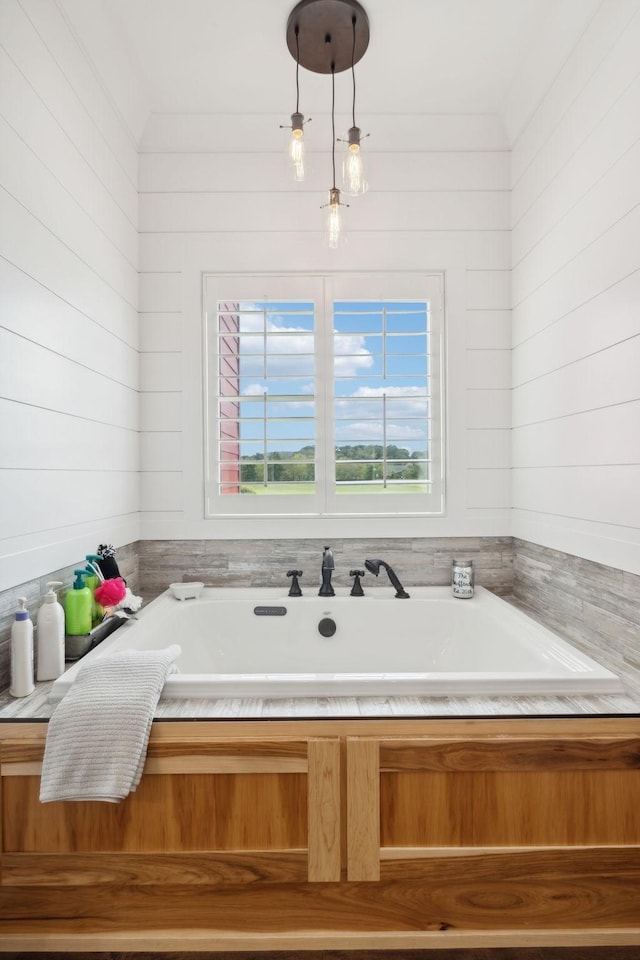 bathroom with wood walls and a tub to relax in