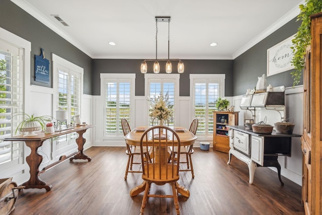 dining space featuring dark hardwood / wood-style floors, plenty of natural light, and crown molding