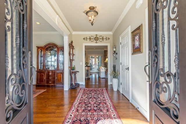 entryway with crown molding, french doors, and dark hardwood / wood-style floors