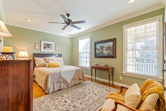 bedroom with ceiling fan, light wood-type flooring, and crown molding