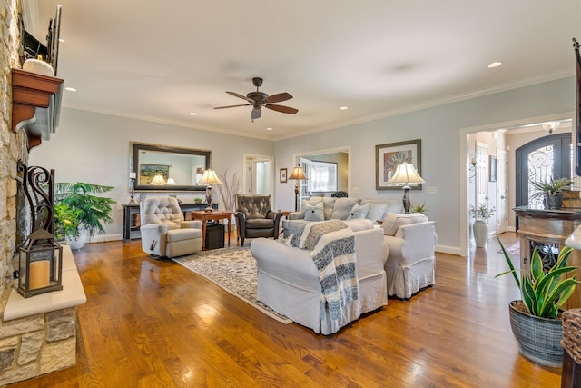 living room featuring ceiling fan, hardwood / wood-style floors, and ornamental molding