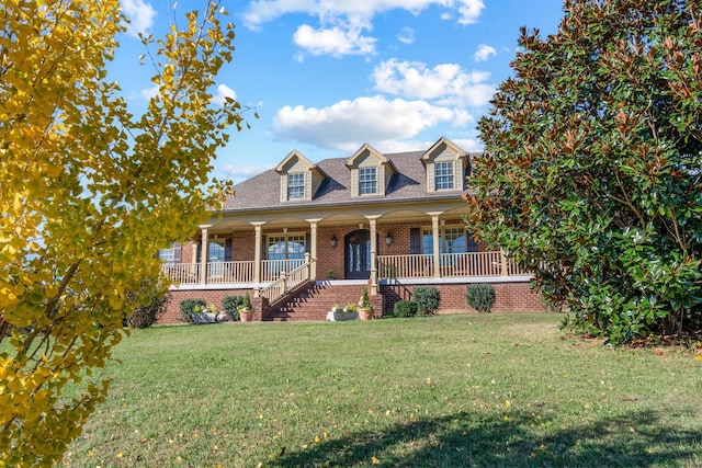 cape cod-style house with covered porch and a front yard