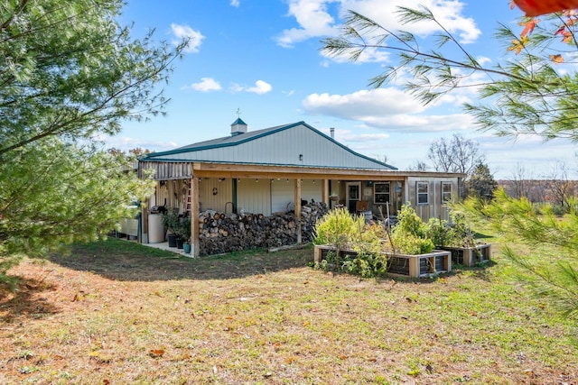 rear view of house featuring a yard