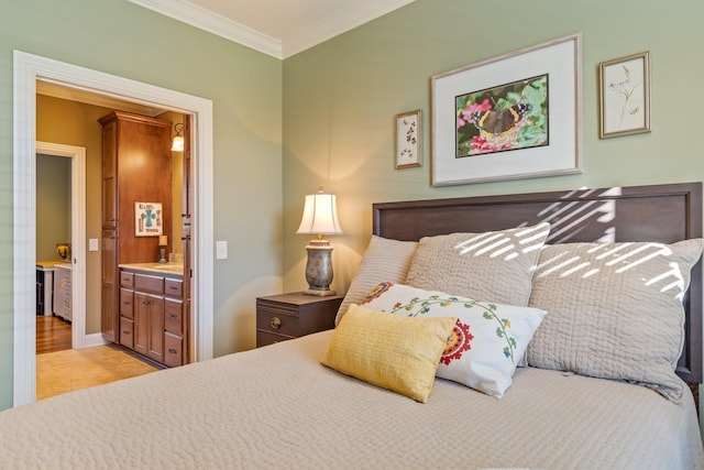 bedroom featuring ensuite bath and crown molding