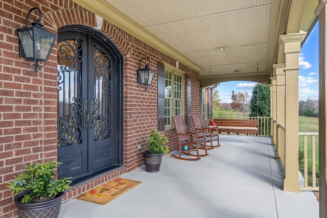 doorway to property featuring french doors and covered porch