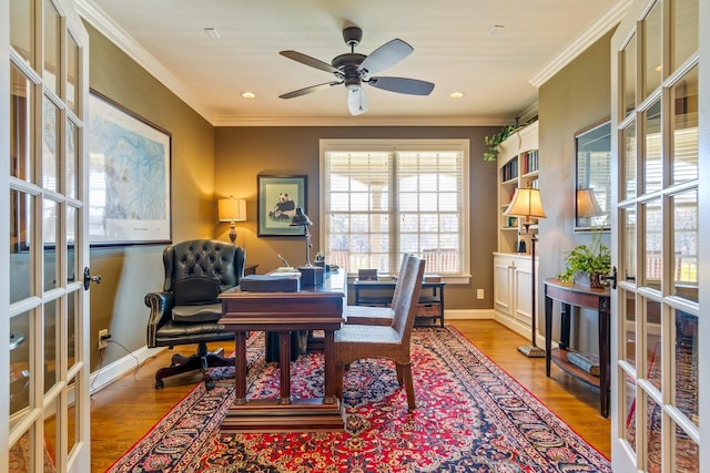 office area with crown molding, french doors, ceiling fan, and light wood-type flooring