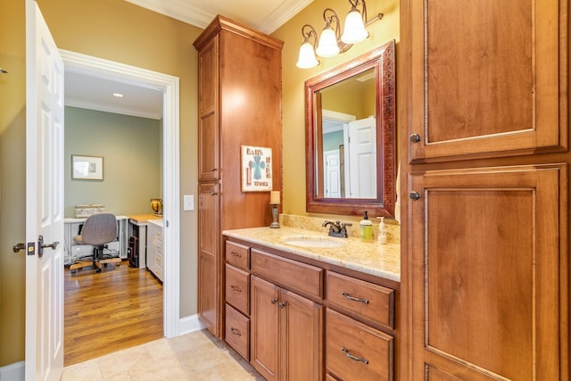 bathroom with wood-type flooring, vanity, and ornamental molding