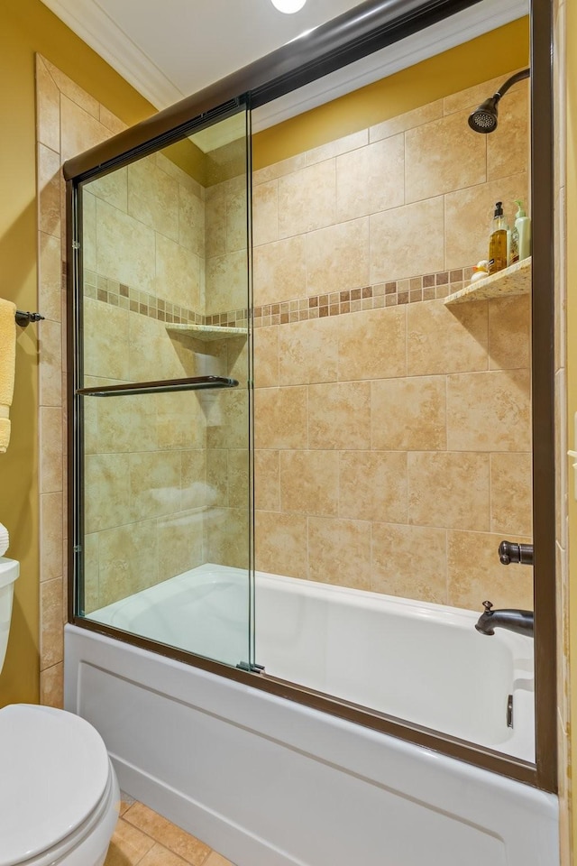 bathroom with tile patterned flooring, toilet, shower / bath combination with glass door, and crown molding