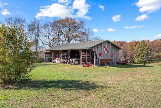 view of front facade with an outbuilding and a front yard