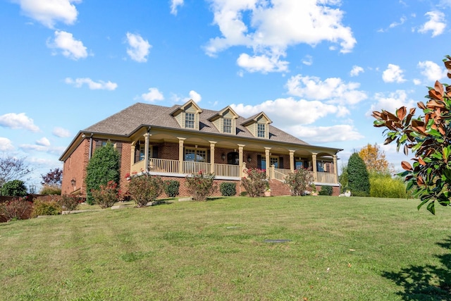 view of front of house with a porch and a front lawn