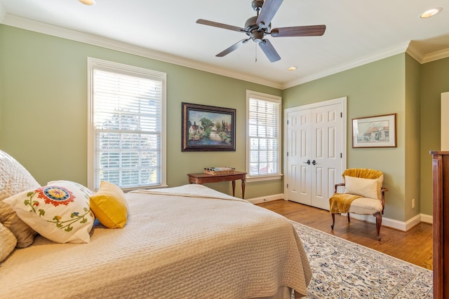 bedroom with multiple windows, ceiling fan, and crown molding