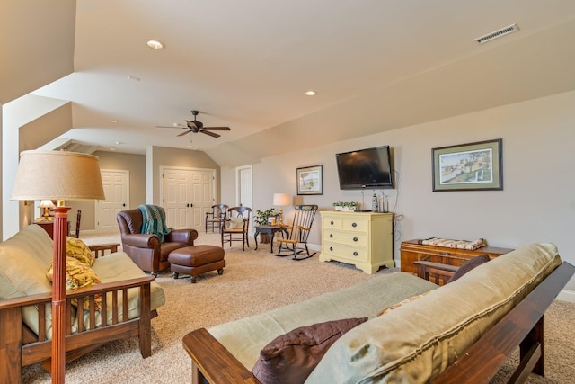 living room featuring carpet floors, vaulted ceiling, and ceiling fan