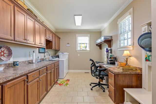 interior space featuring crown molding, sink, cabinets, and washer and dryer