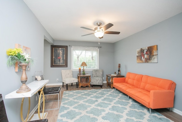 living area with hardwood / wood-style flooring and ceiling fan