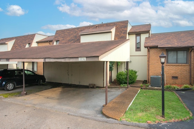 view of front facade featuring a carport and central air condition unit