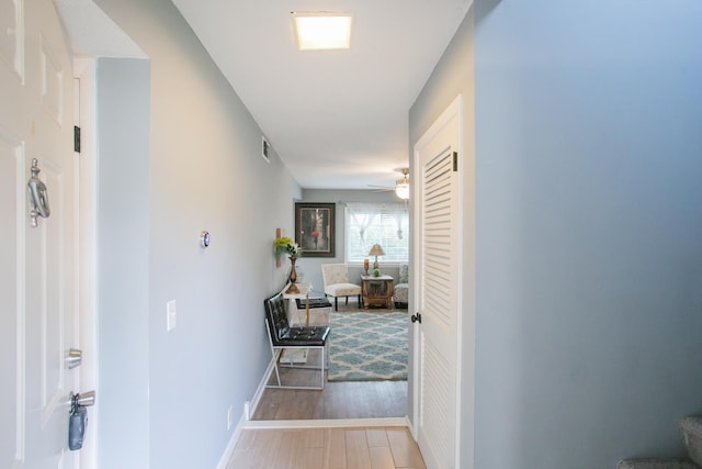 corridor with light hardwood / wood-style floors