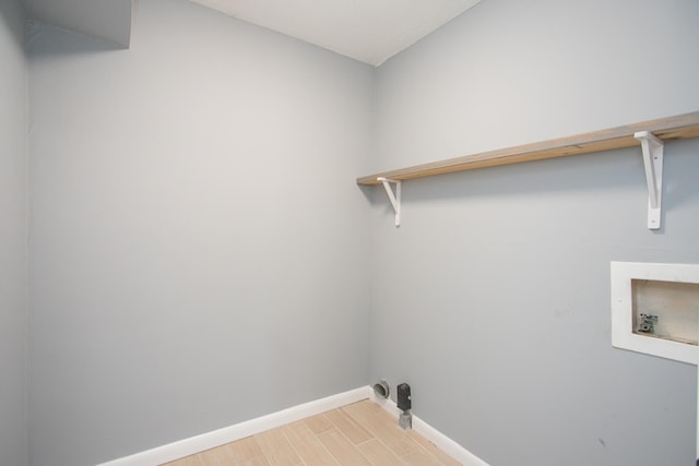 washroom featuring washer hookup and light hardwood / wood-style floors