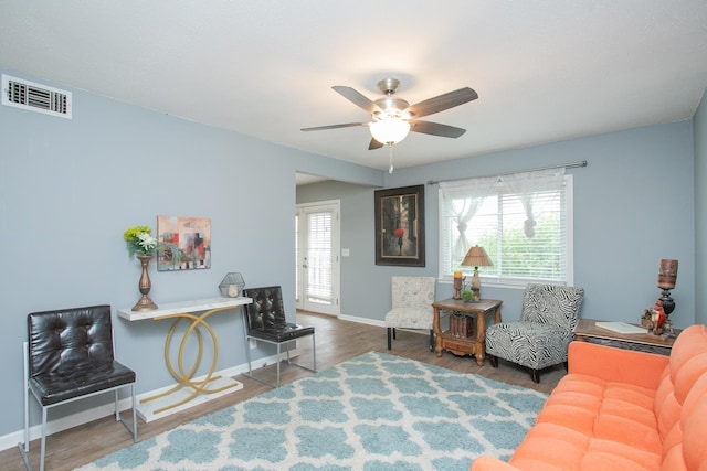 living room featuring ceiling fan and hardwood / wood-style floors