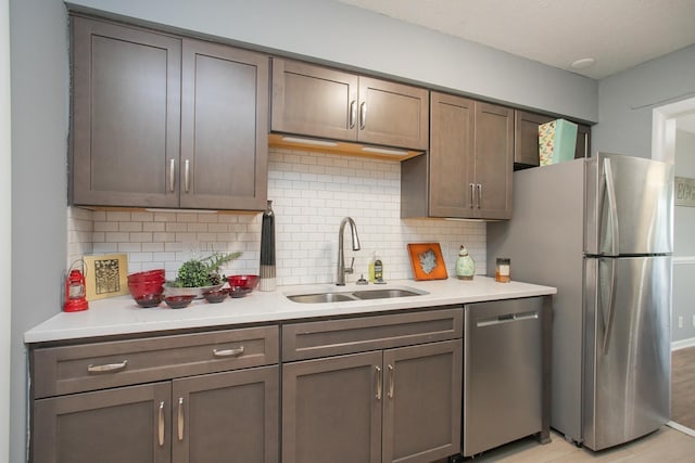 kitchen featuring appliances with stainless steel finishes, backsplash, and sink