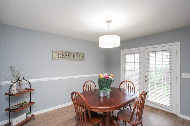 dining space featuring wood-type flooring