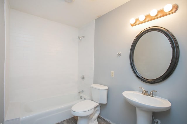 full bathroom with bathing tub / shower combination, hardwood / wood-style flooring, sink, and toilet