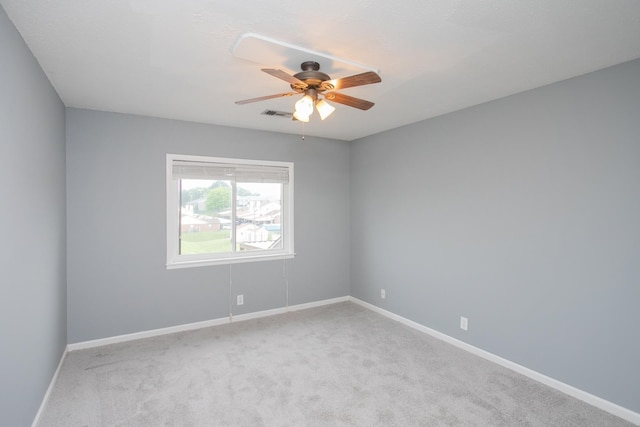 carpeted empty room featuring ceiling fan