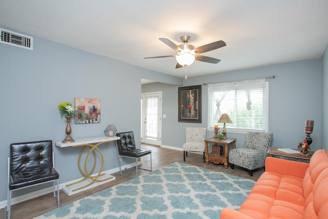 living room featuring dark hardwood / wood-style floors and ceiling fan