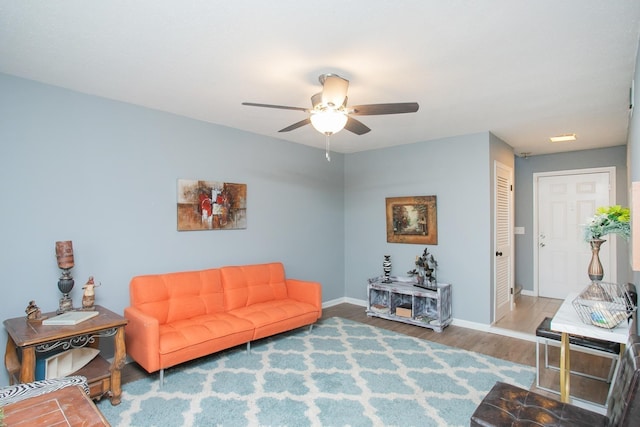 living room featuring ceiling fan and hardwood / wood-style flooring